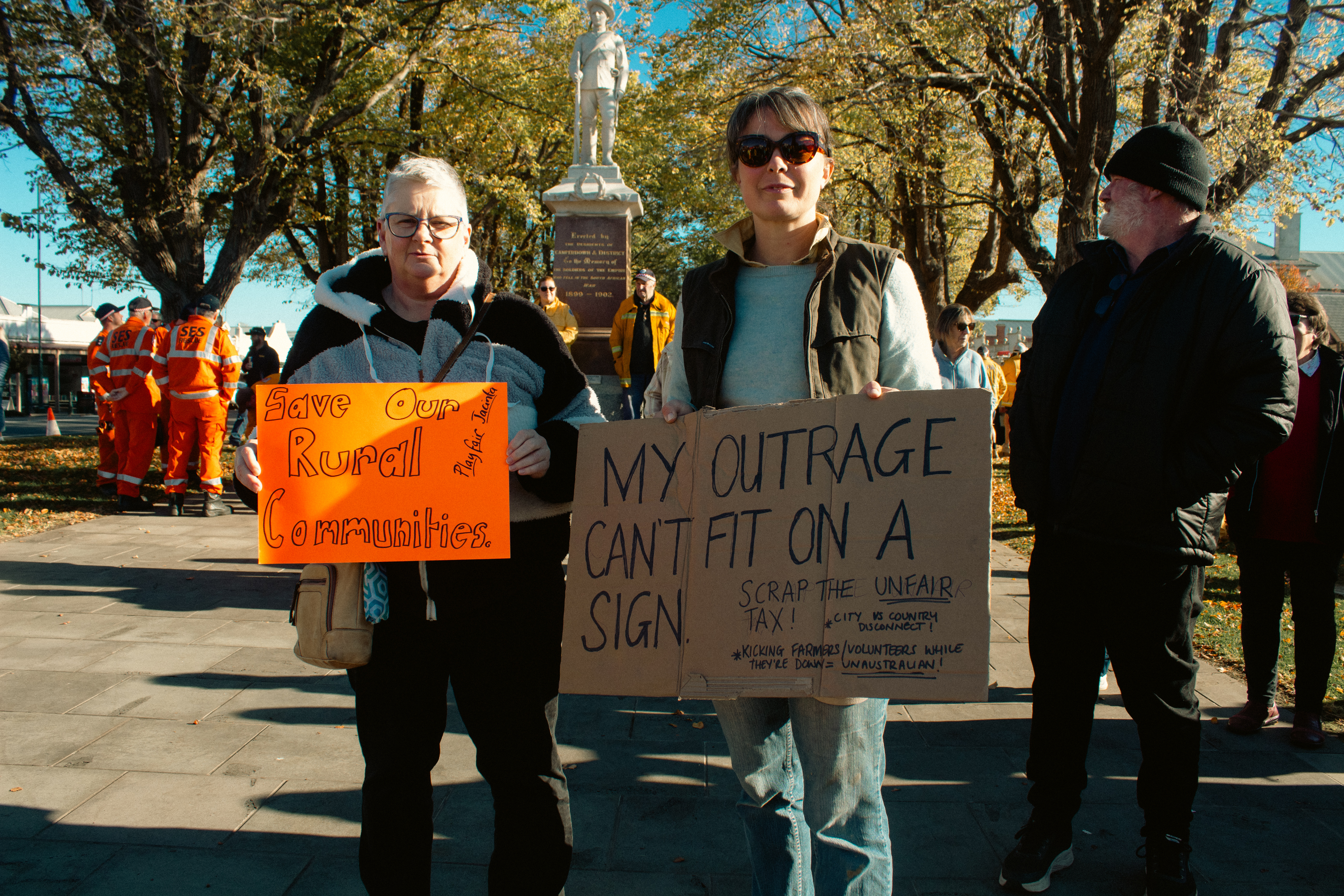 Community members holding protest signs at a local rally