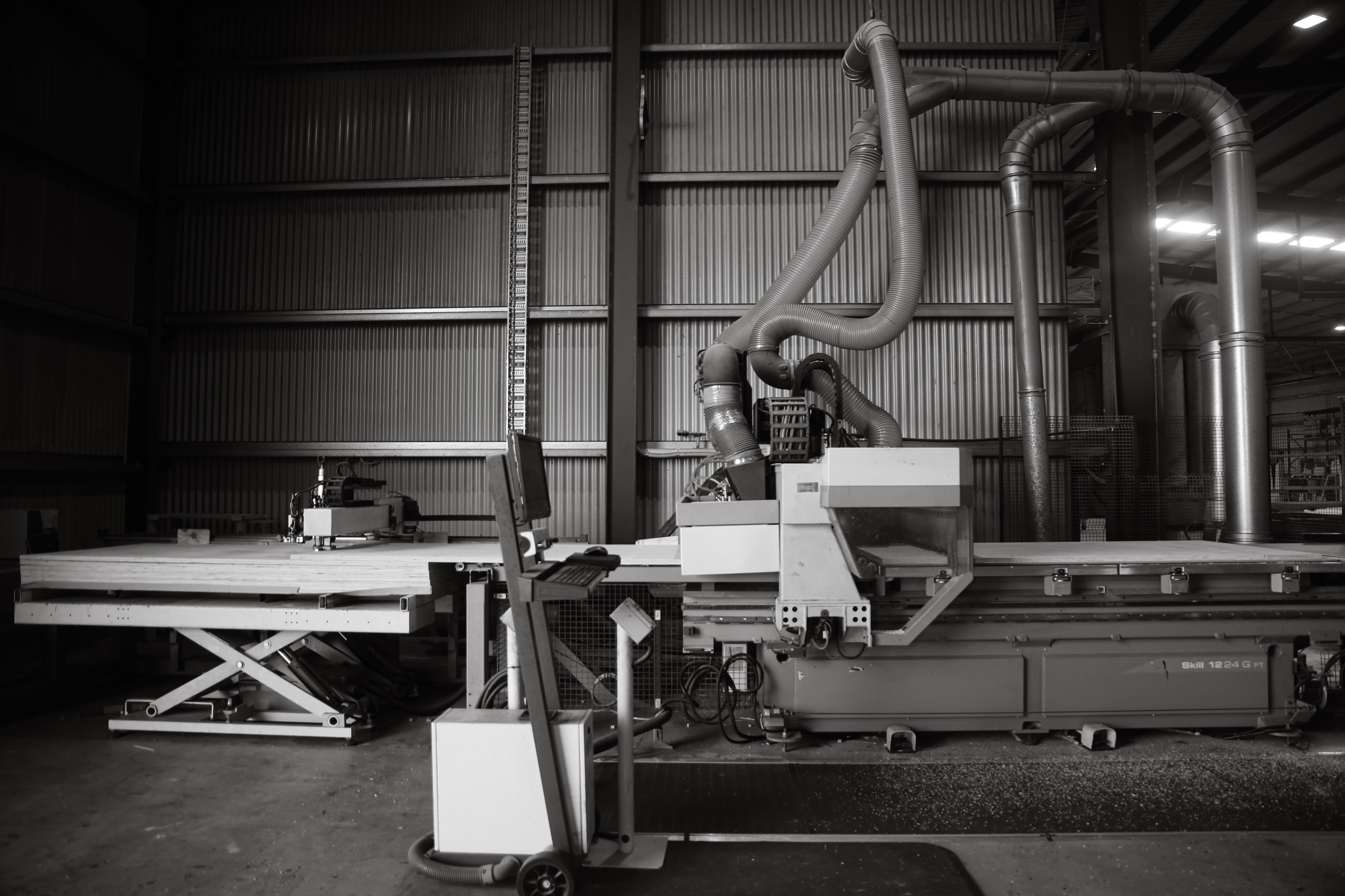CNC machine inside a timber shed, black and white landscape