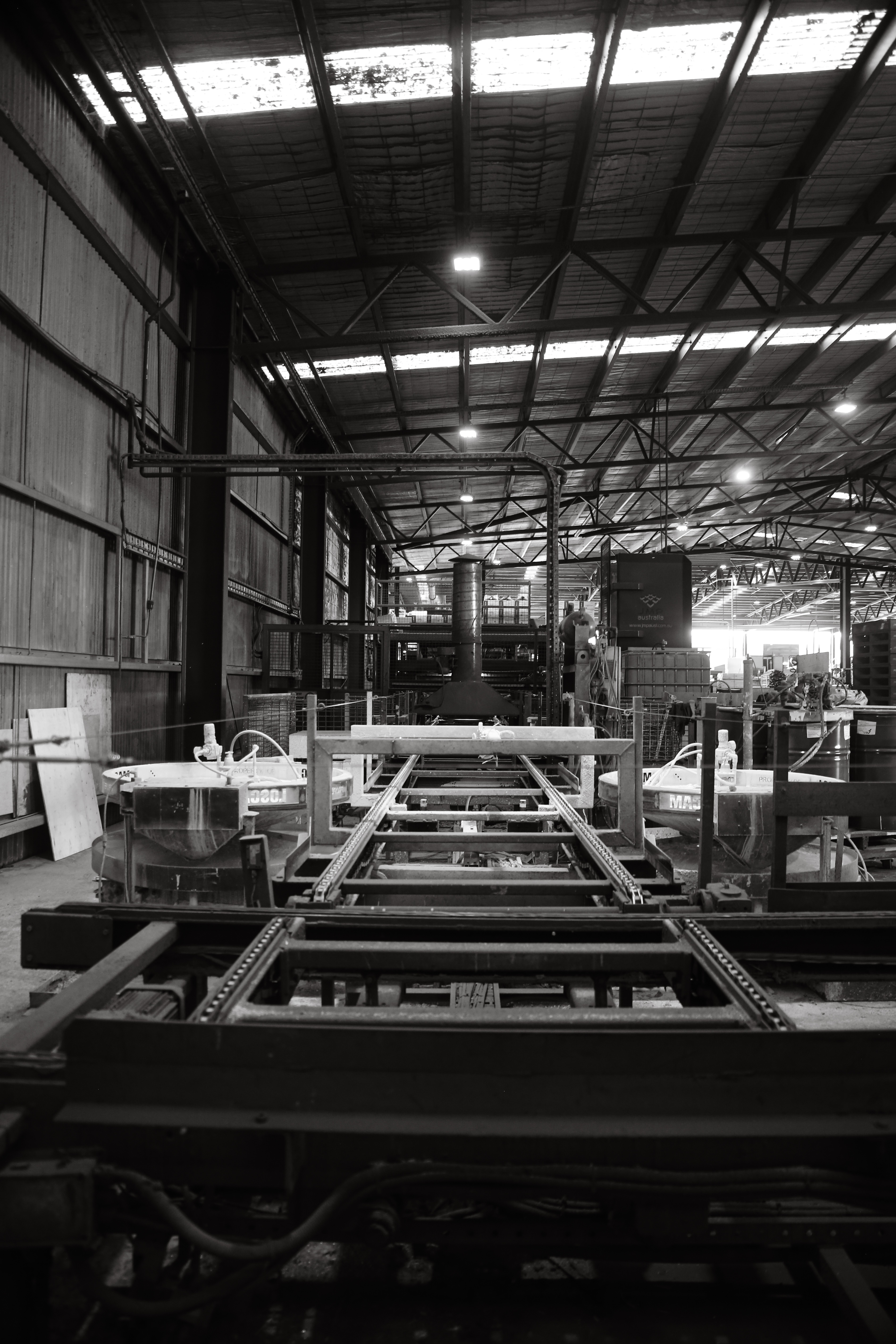 Dark industrial machinery viewed through a cage, black and white portrait
