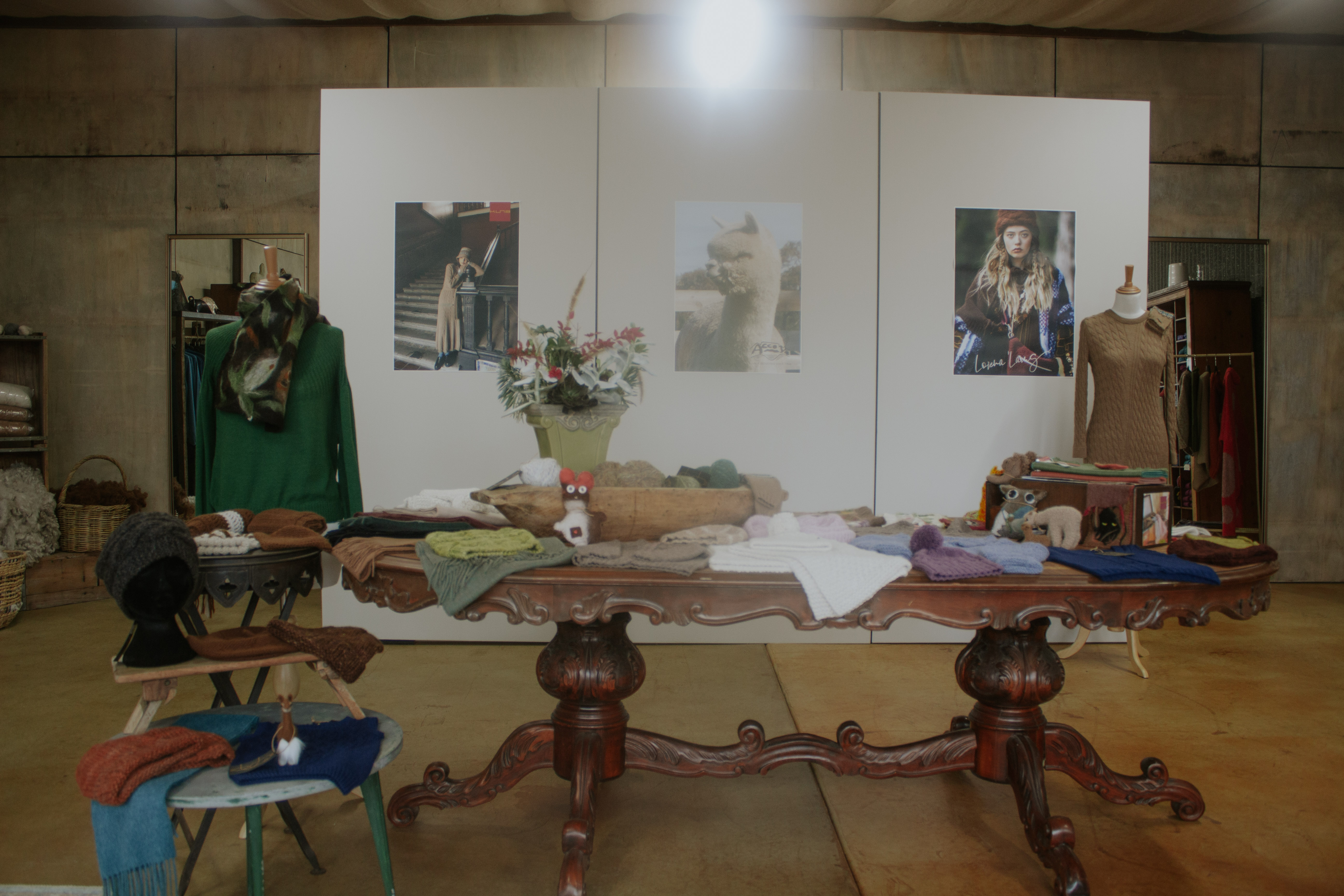 Showroom studio with mood board and garments laid on an antique table