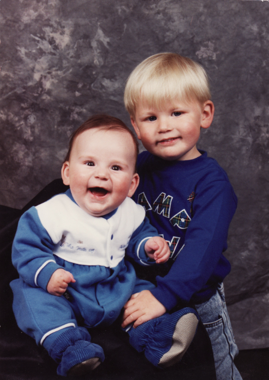 Chris Gillin as a young boy holding his baby brother.