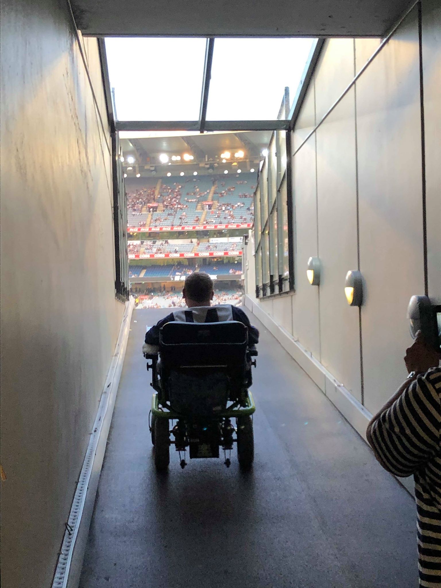 Chris Gillin heading toward the stadium in his wheelchair.